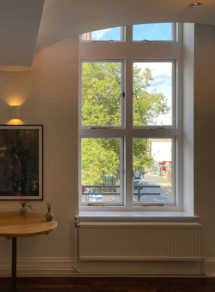 A window which has six panes of glass that have been protected with a window film to prevent the glass from shattering.