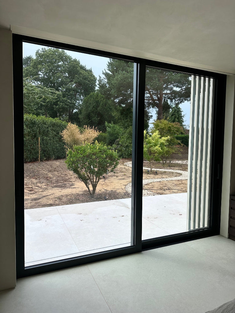 Clear security window film applied to the inside of a patio door to help hold the glass together if it breaks.