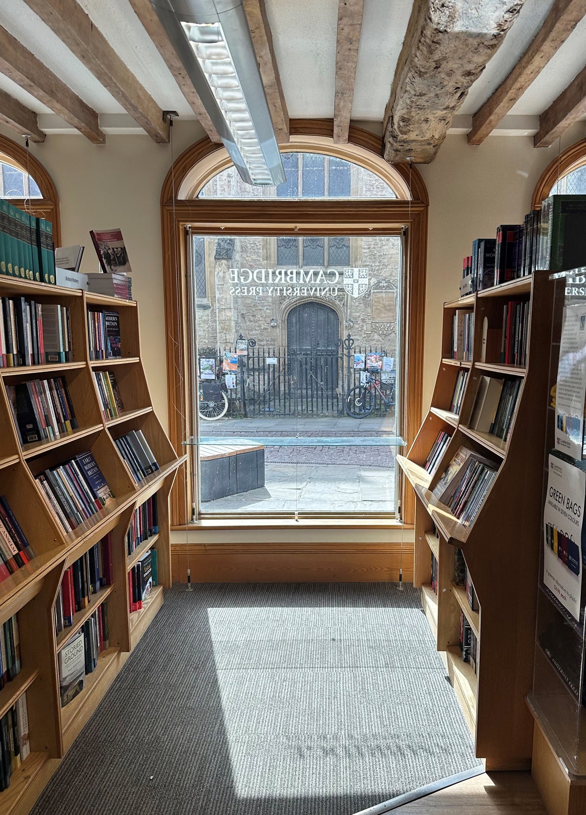 An internal view of a bookshop with a large window that has had clear safety window film applied.