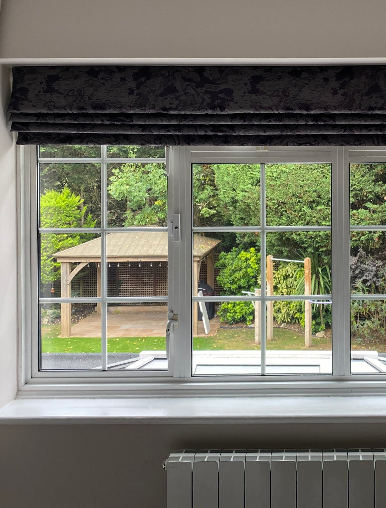 A close up of a window in a house that has has clear security window film applied.