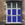 Window set into a brick wall, split into six panes with solid coloured blue window film applied to each pane