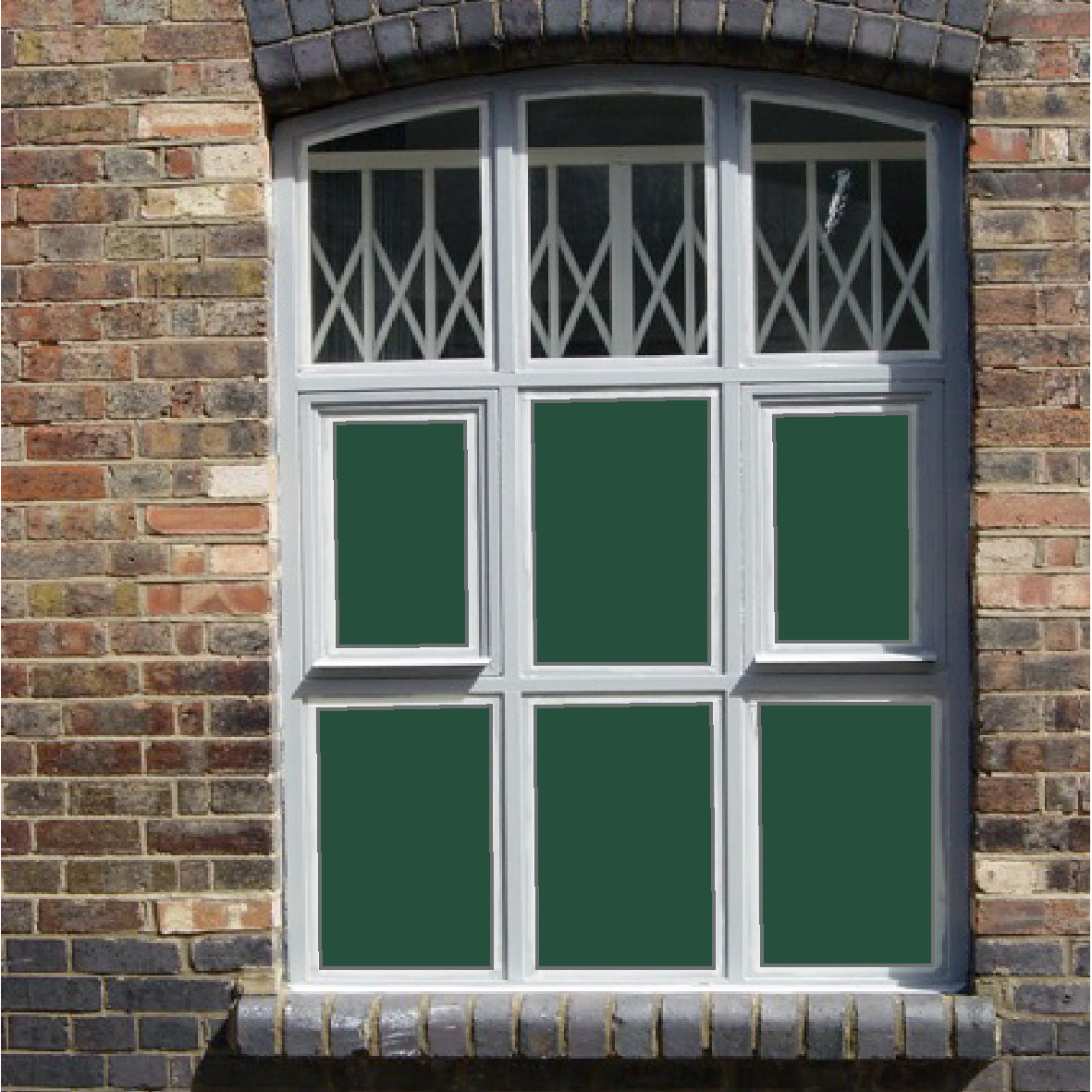 Window with six panes and solid green coloured window film applied to each panel
