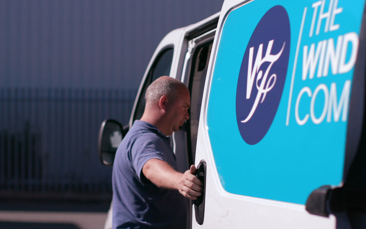 A window film installer opening the door of a van from The Window Film Company
