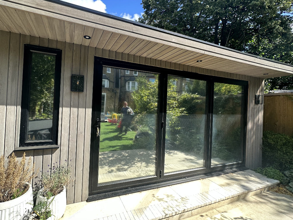 Outside of a garden room after mirrored window film has been installed.