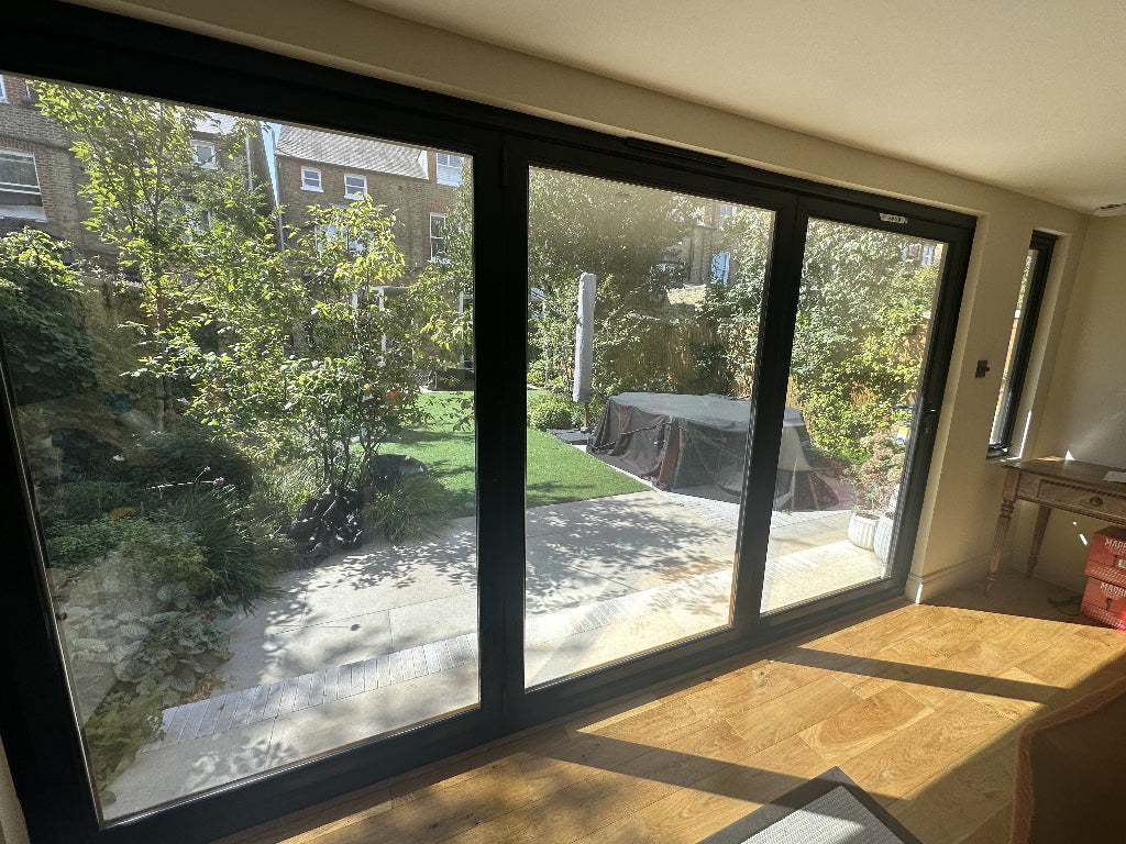 Large windows of a garden room which have has privacy film fitted for one-way vision.