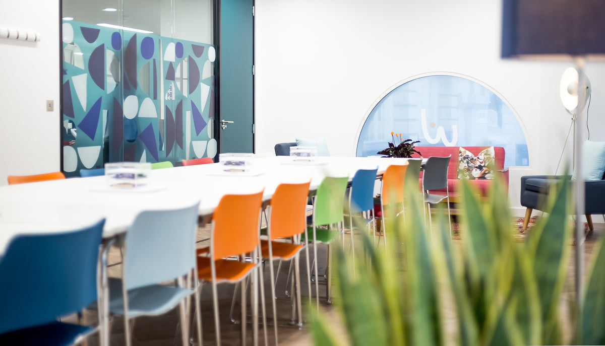 Printed graphics applied to glass in a modern, colouful office setting