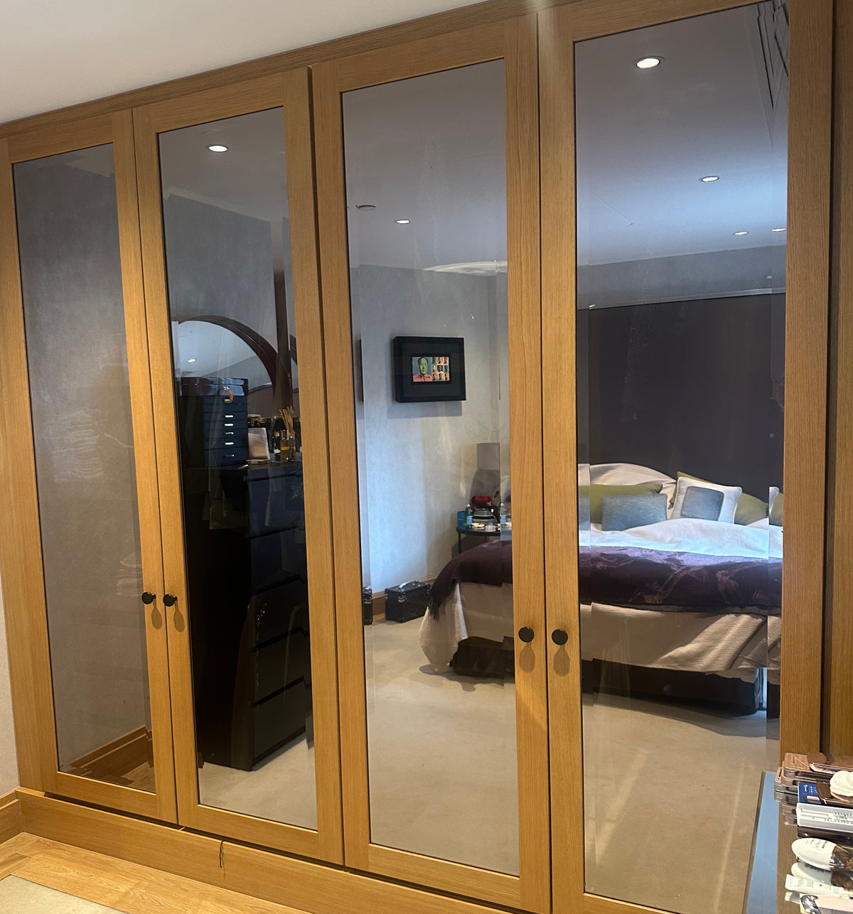 Wooden wardrobe in a bedroom setting with solar bronze window film applied to block the view into the wardrobe