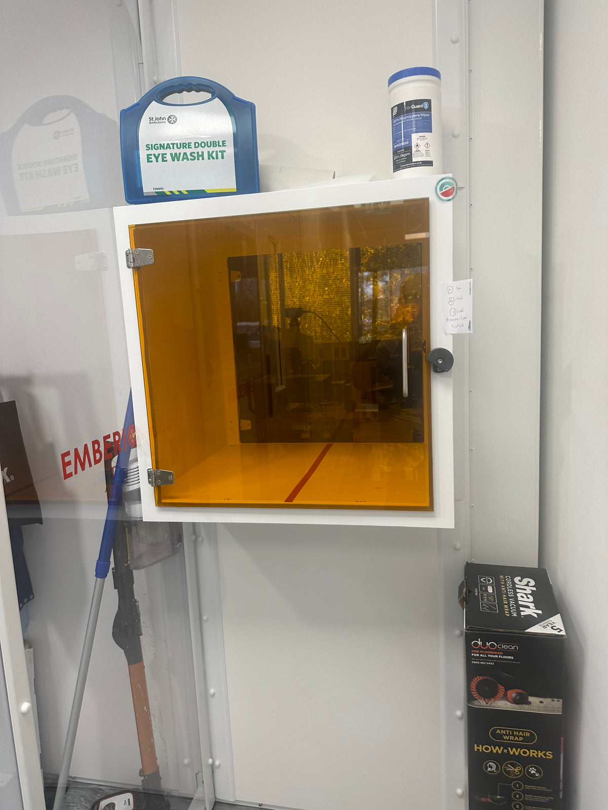 Storage container with a glass door, with Amber 81 UV protection window film applied to it. 