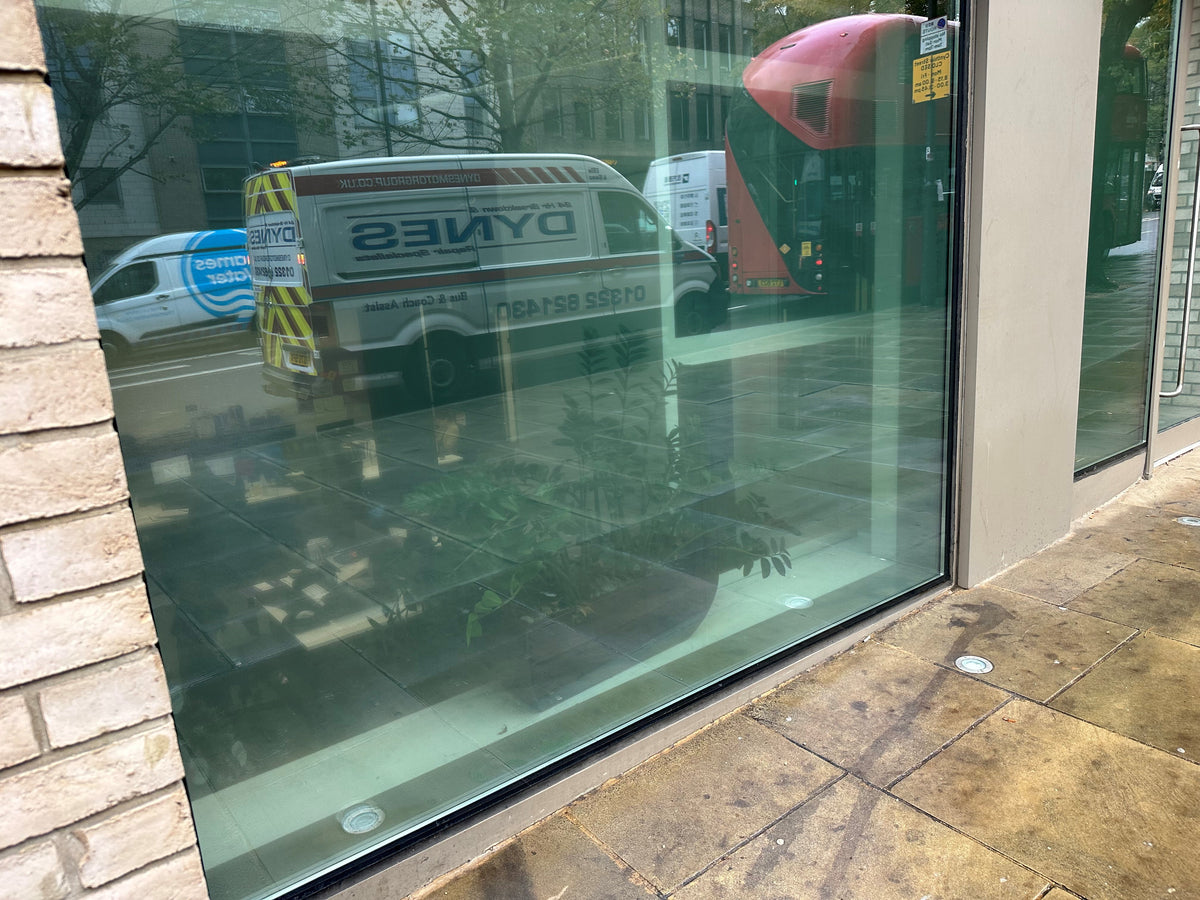 External view of a glass frontage with anti-graffiti window film applied to the glazing. 
