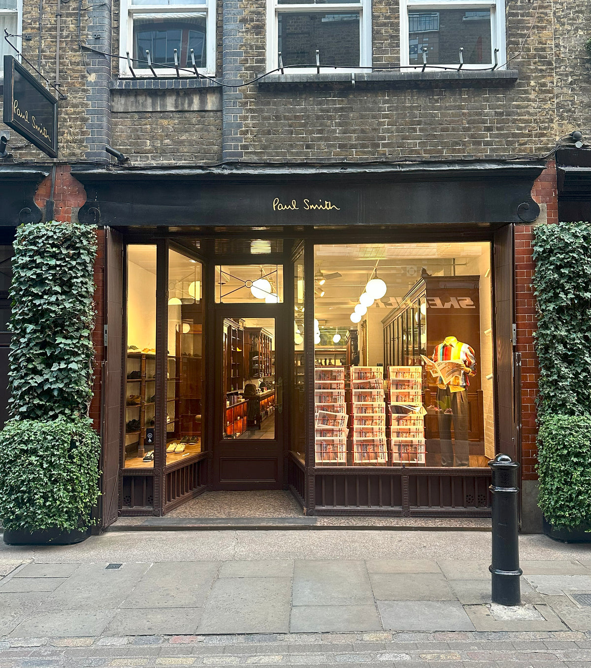 Paul Smith store front with glass windows displaying products