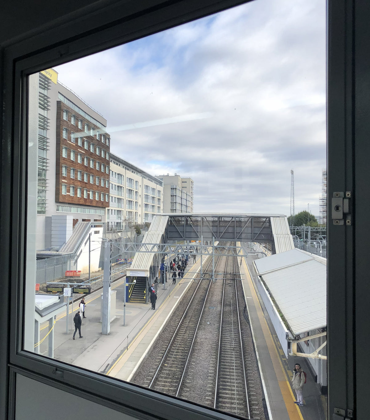 Train station platform viewed through a window which has anti graffiti window film applied.