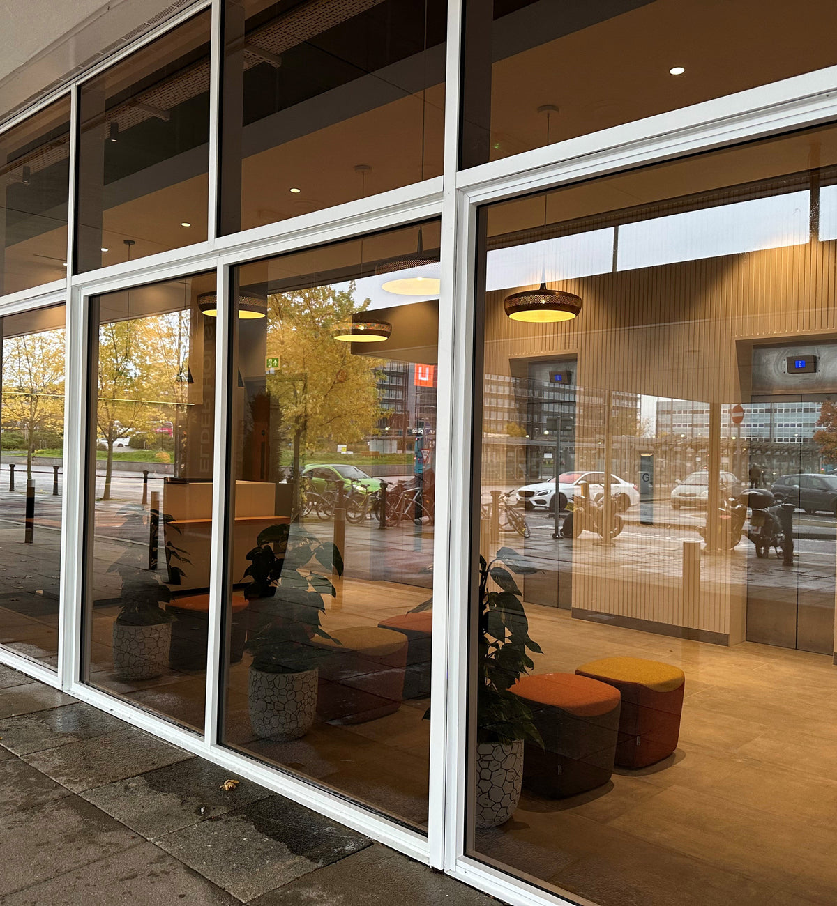 Modern building with glass frontage. The glazing features a light Black Pearl tinted window film, giving it a tinted appearance without blocking the view to the inside. 