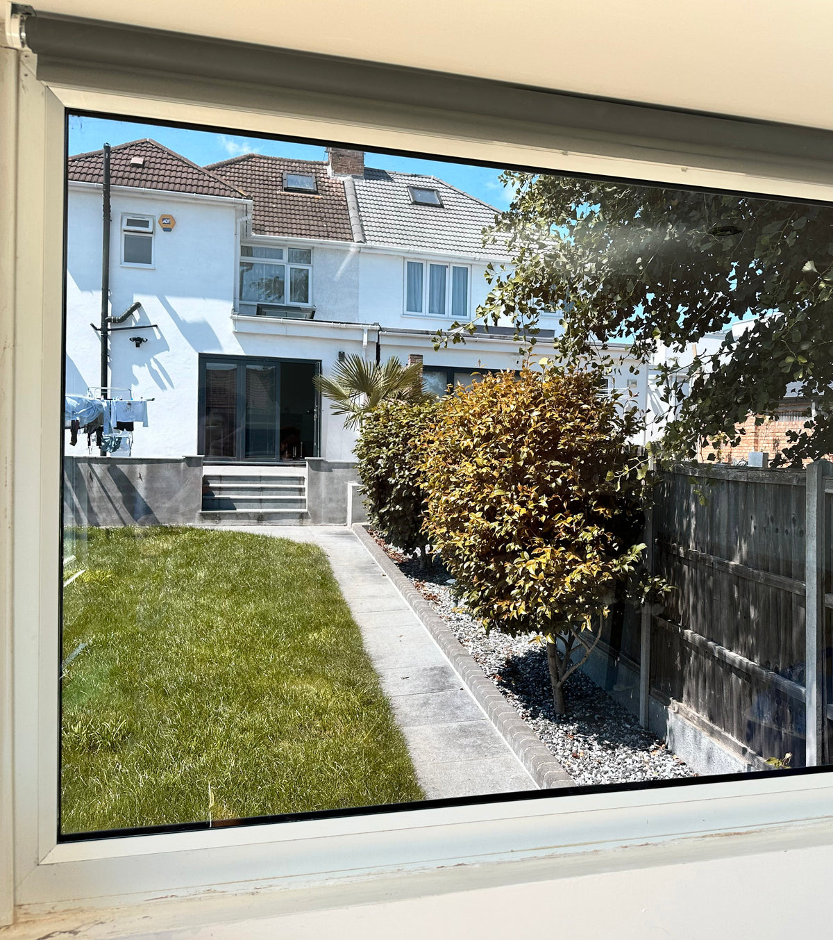 View out through a garden room window. The window has had Black pearl tinted window film applied for glare reduction. 