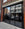 A shopfront with four large glass panels, each of which has had tinted glare reduction window film applied, delivering a stylish dark appearance. 