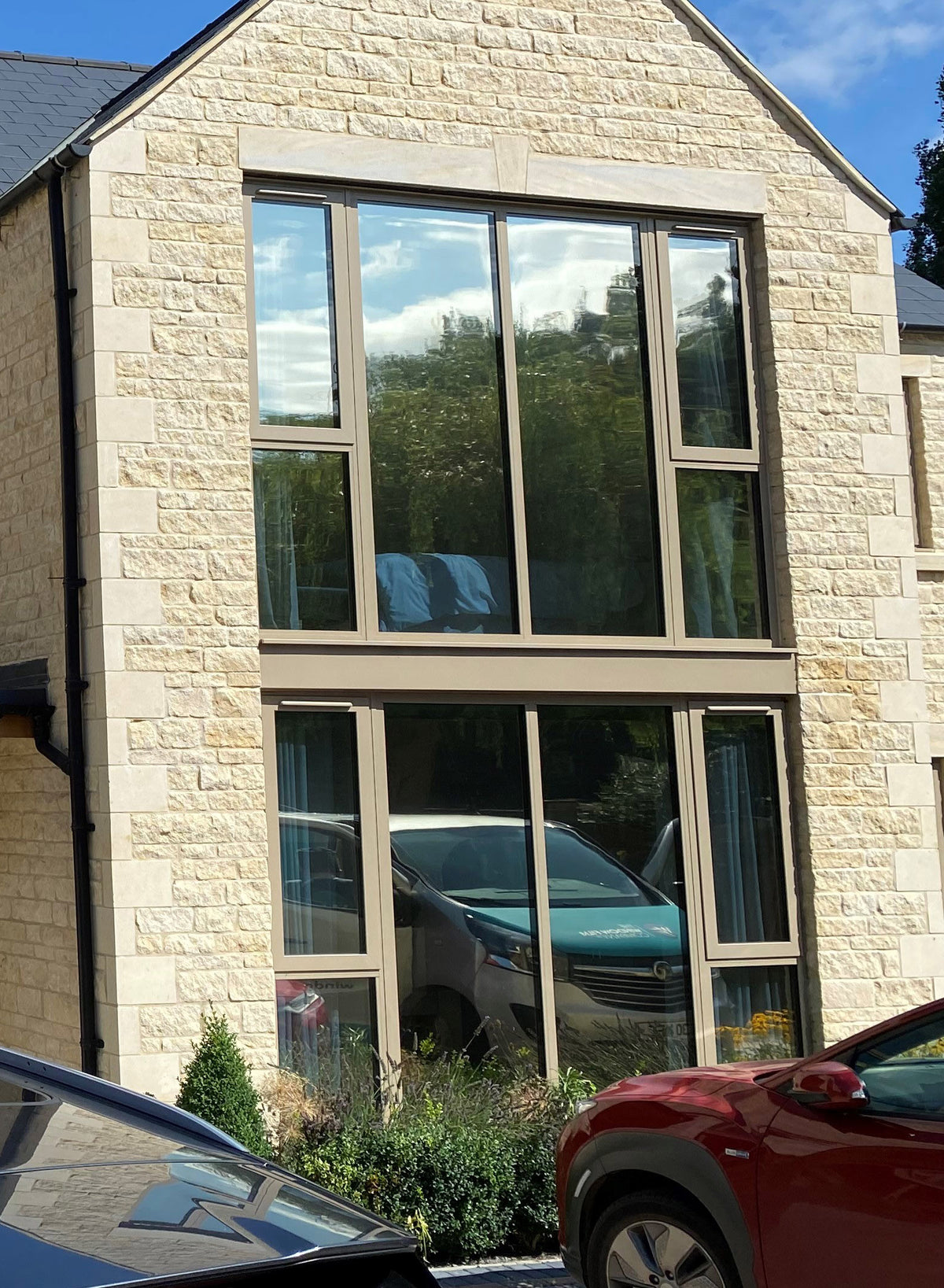 A residential property with large glass windows that have Climate 35 solar control window film applied to them.