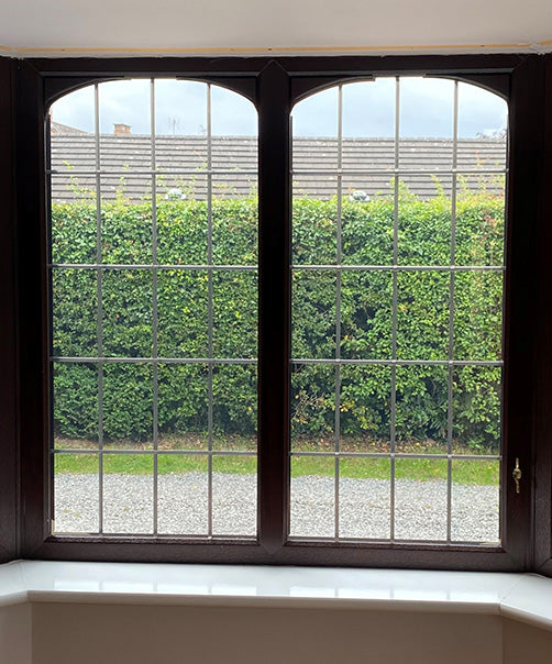 Internal view of a window with window film for heat and glare reduction applied, with a view to the outside.