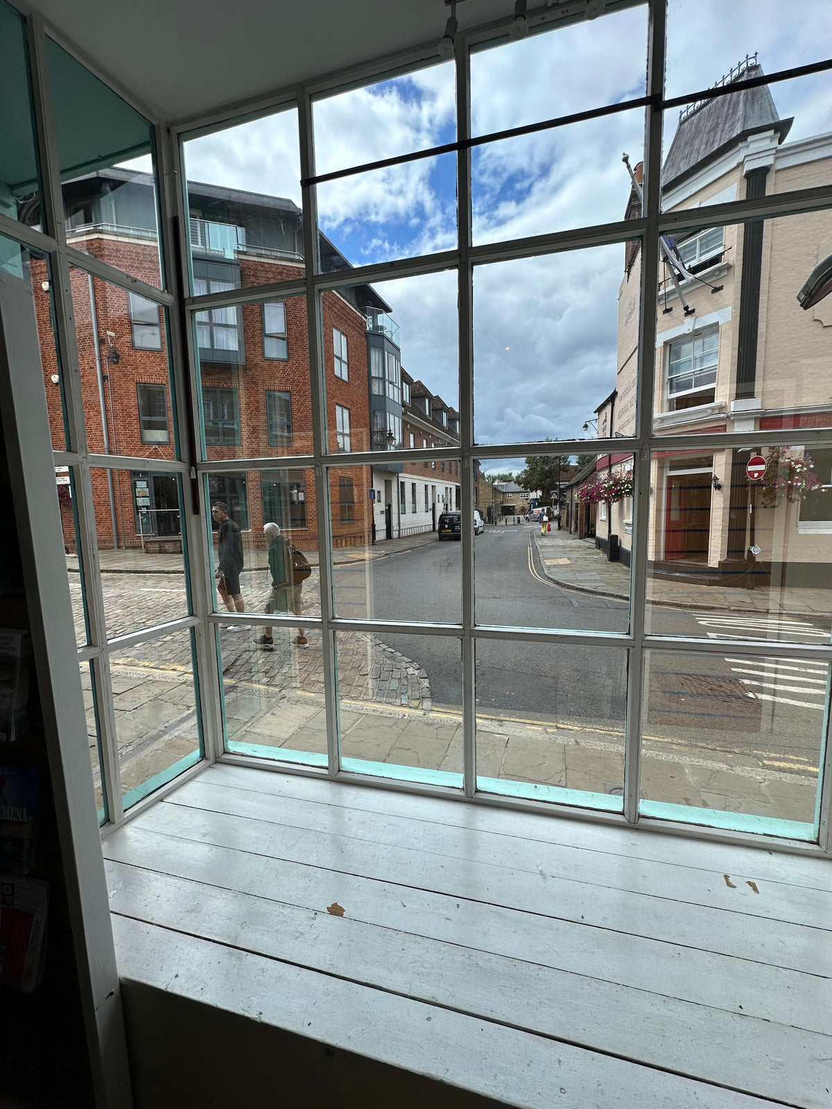 The inside of a shop which has solar control film applied to multiple panes of small glass windows.