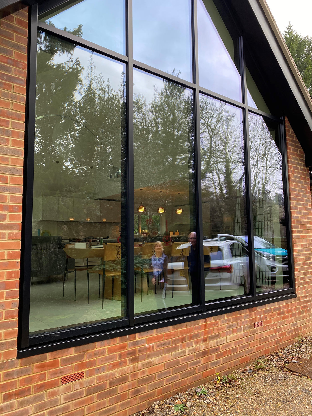 A large triangular shaped window that has had a Climate 70 light solar control window film applied to it.