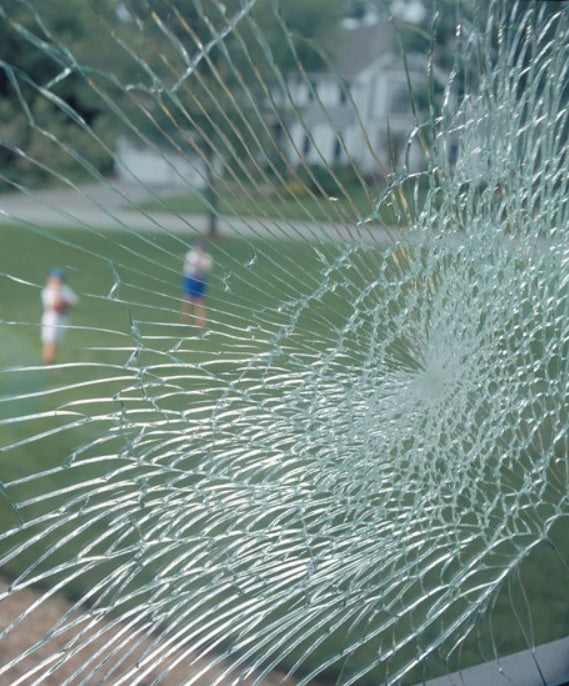 A window has been broken, but the glass is held together.