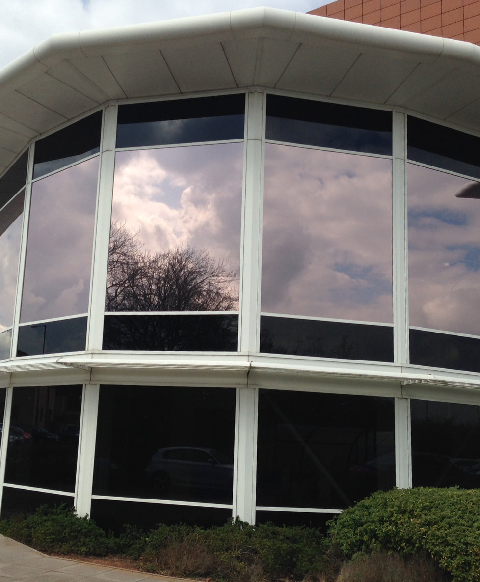 Modern building facade with large glass windows which have Solar Bronze window film applied to reduce excess heat and glare
