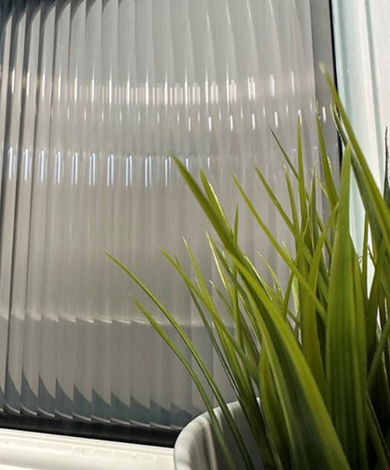 Close up of a smoked verision of evoke reeded window film
