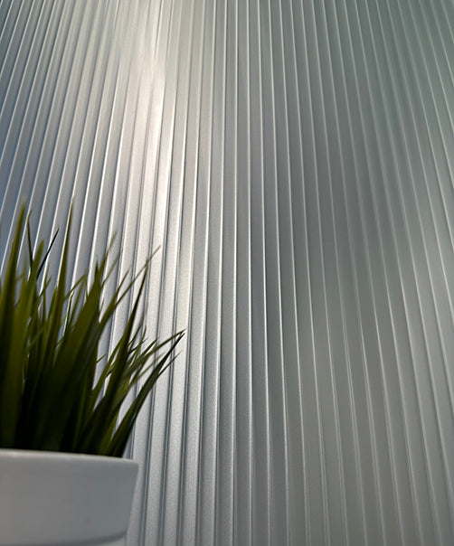 A window with a frosted reeded film applied to the glass.