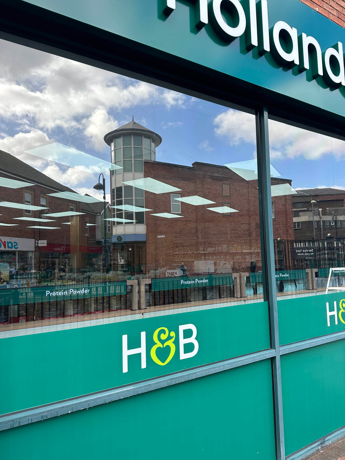 Light reflective Silver heat reduction window film applied to the external face of a shopfront.