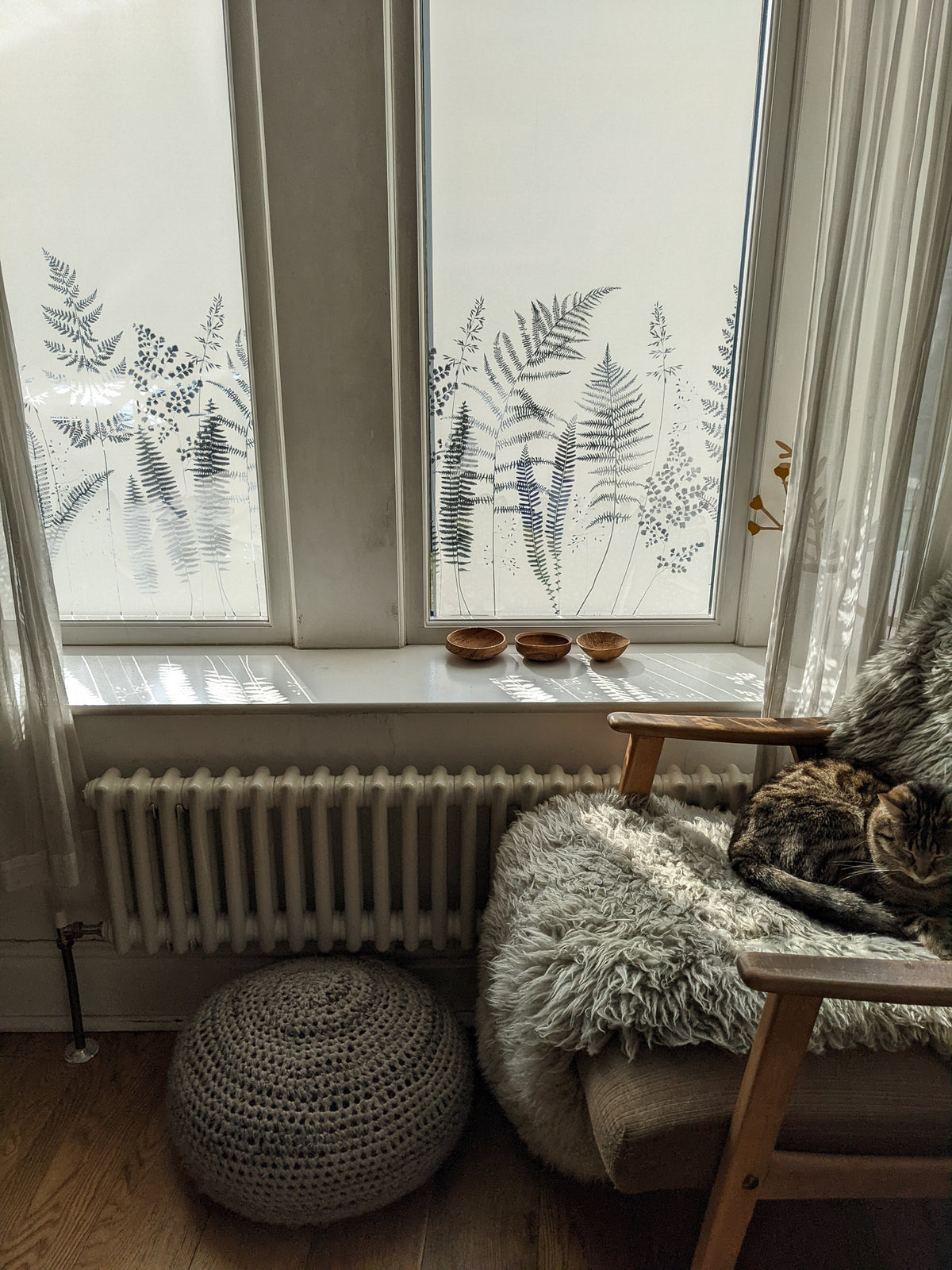 Cozy corner with a window that has a natured themed frosted window film for privacy.