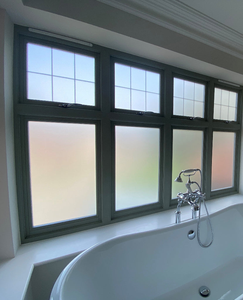 Bathroom with frosted window film applied to the inside of the glazing for privacy.