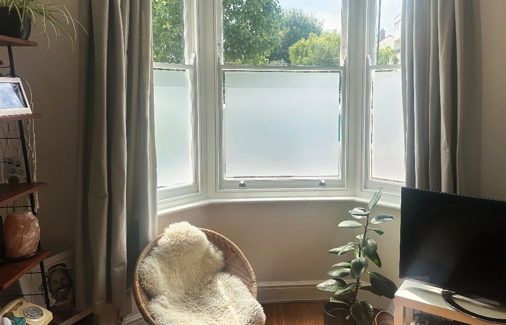 Living room bay window which has had frosted window film applied to the inside with a small clear border left around the edge.