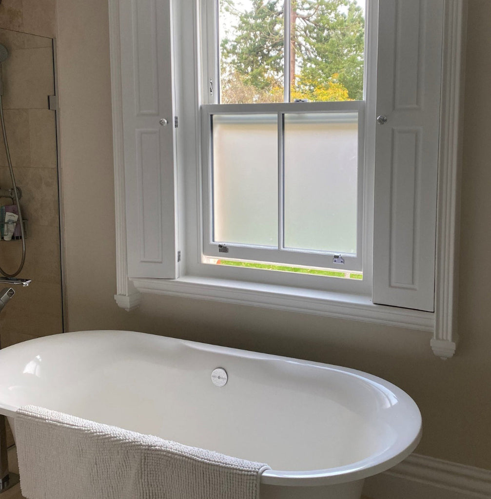 Frostbrite frosted window film applied to the lower panes of a traditional sash window of a bathroom for privacy.