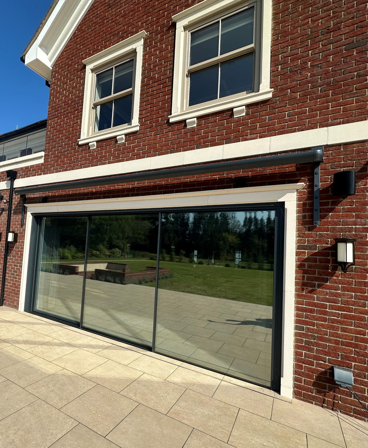 Large sliding patio doors which have had solar control window film applied to them.