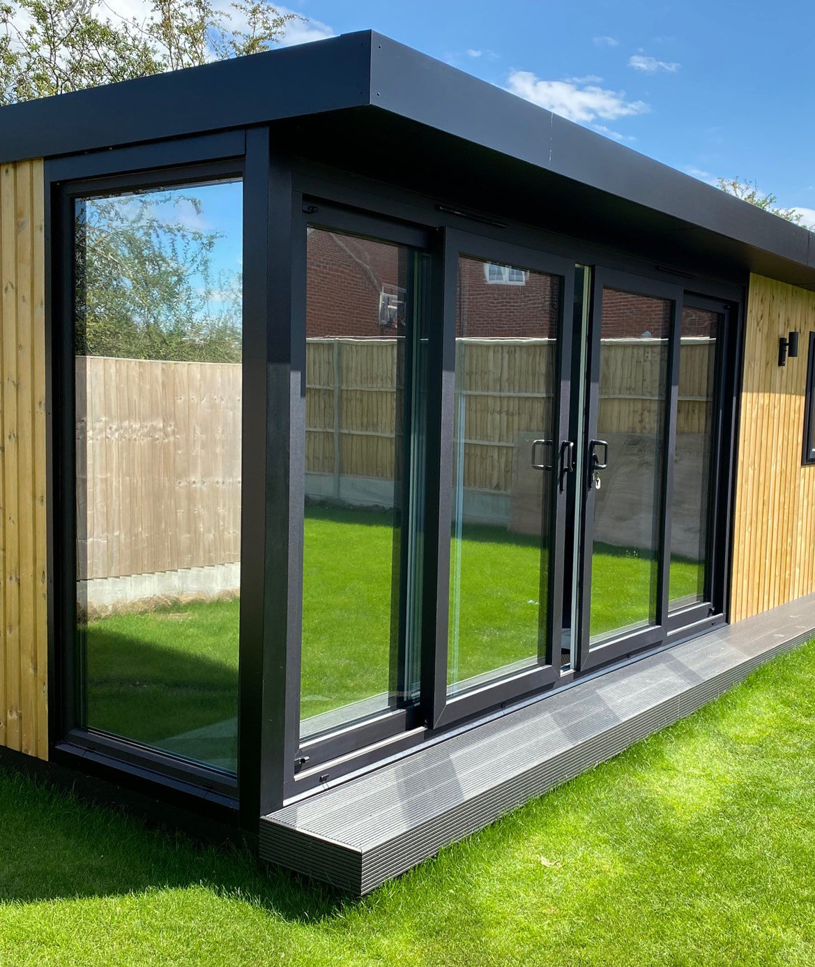 Garden room with reflective window film for solar control and privacy applied to the windows and doors