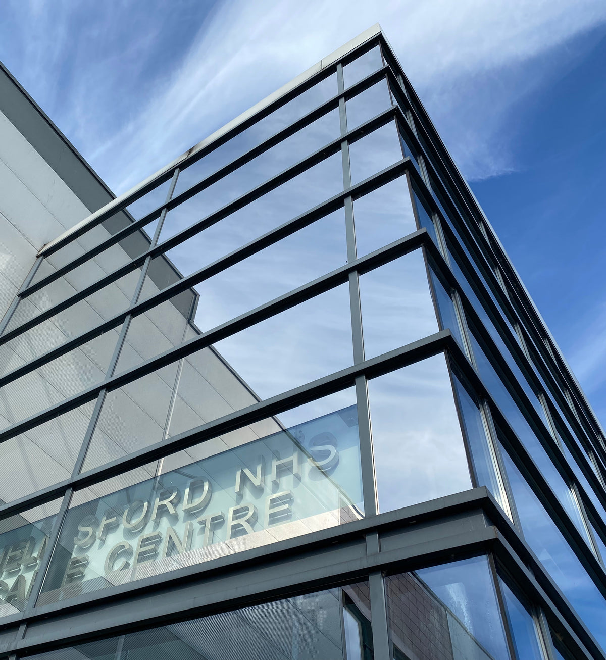 Modern building with reflective solar control window film applied to the glazing