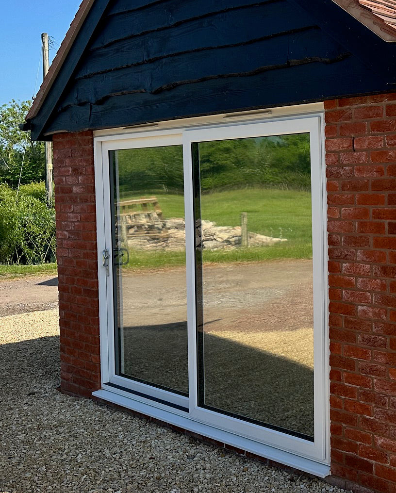 Patio doors featuring reflective solar control window film