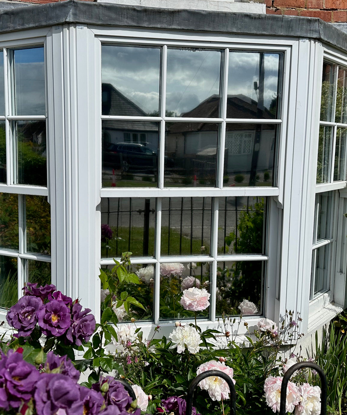 A view of a residential home, with reflective solar control window film applied to the glazing.