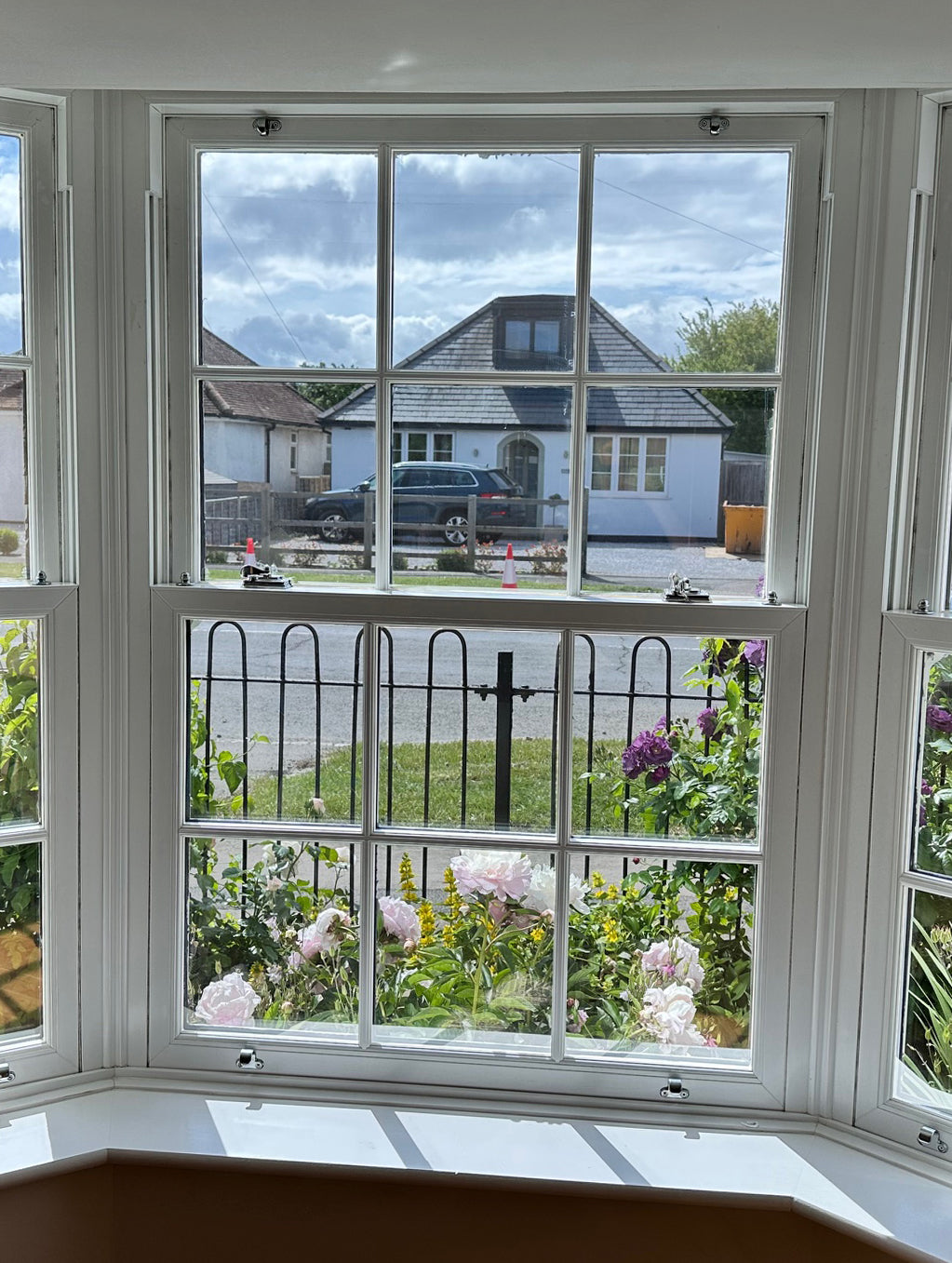 An internal view of a window in a  residential property. The window has solar control window film applied to the glass with a view through the window to the street outside.
