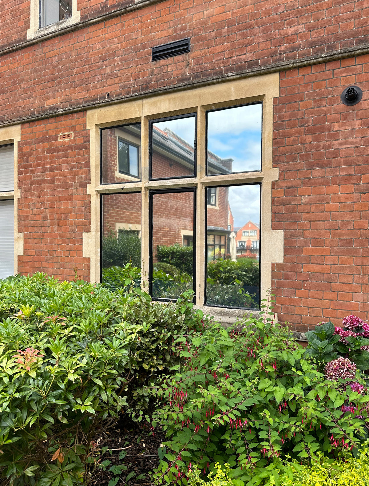 A window split into 6 panes, with solar control reflective window film applied to them. 