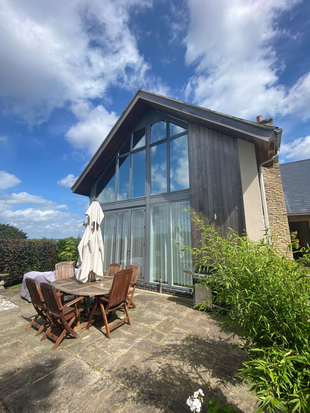 Modern house with large windows with light reflective solar control window film applied