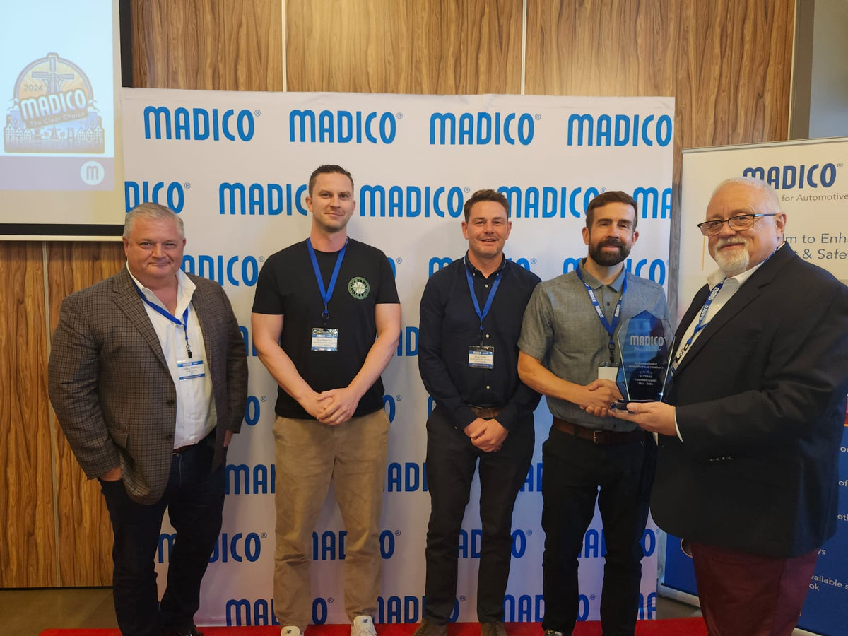The Window Film Company receiving an award from Madico Window Films for their distribution partnership.