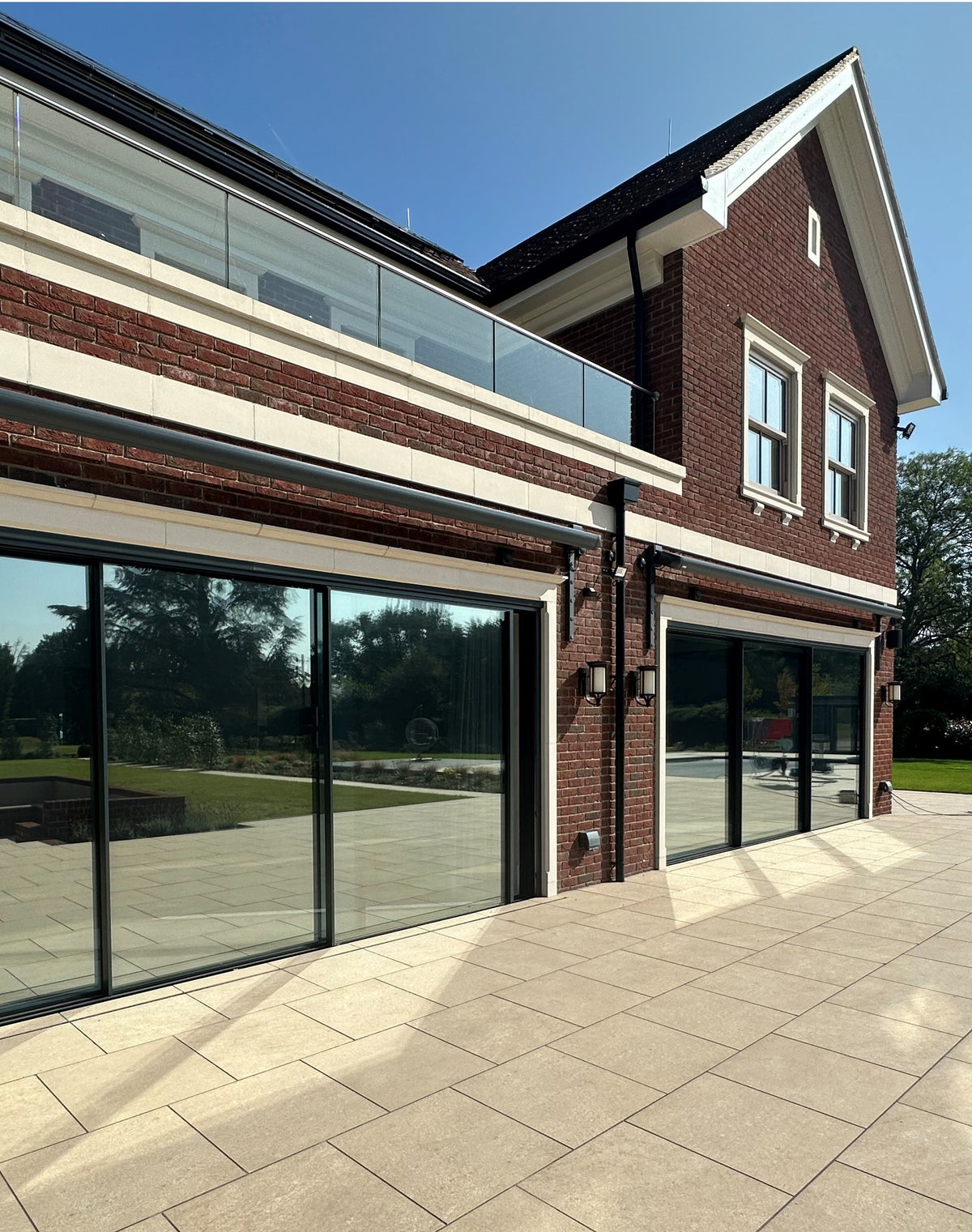Modern home with reflective solar control window film applied to the large glass windows. 