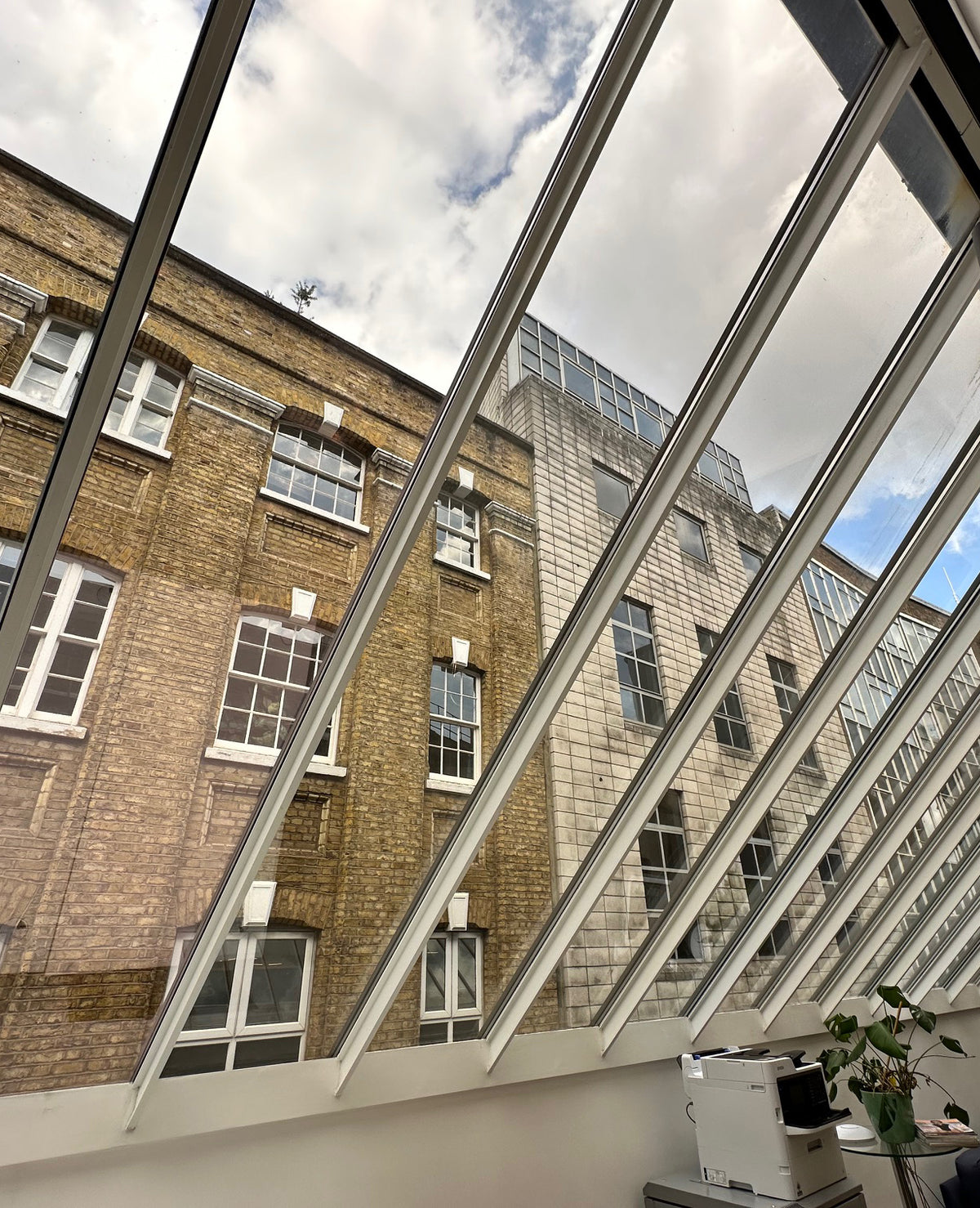 Internal view of an office with large windows set in the roof. The glazing has solar bronze heat reduction window film applied, that allows a view from the inside out. 