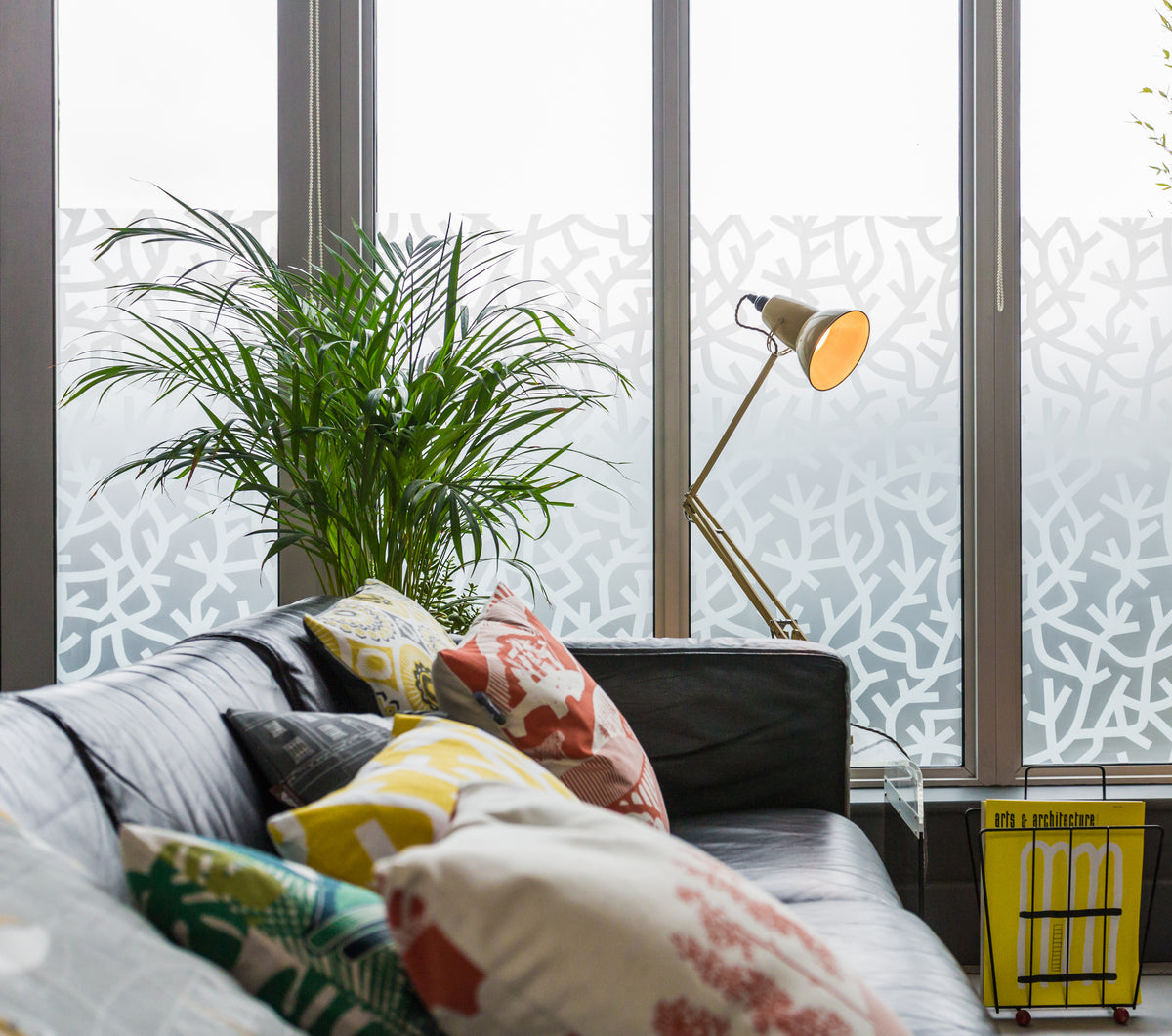 A Forest by Mini Moderns printed in white ink onto frosted film in collaboration with The Window Film Company in a mid century room style.