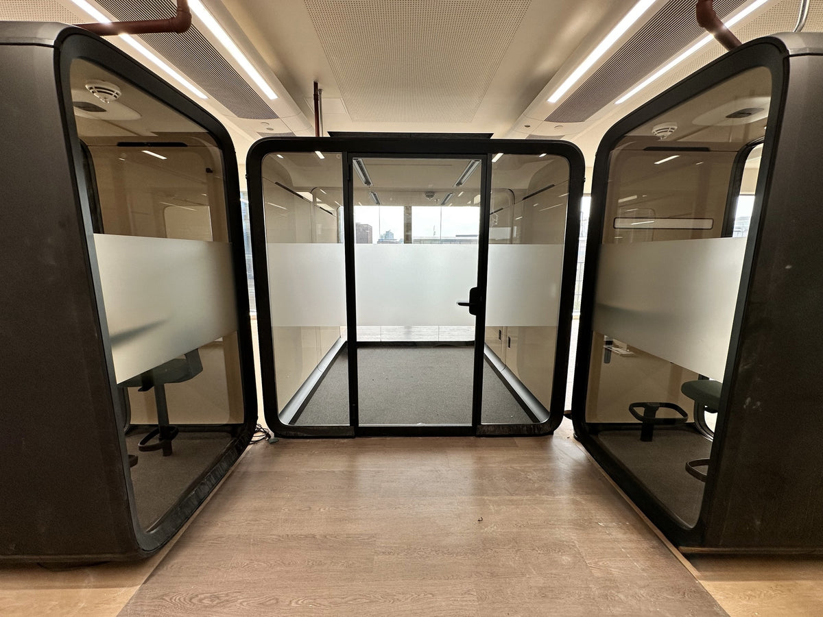 Three meeting room office pods with a band of frosted window film applied to the glass.