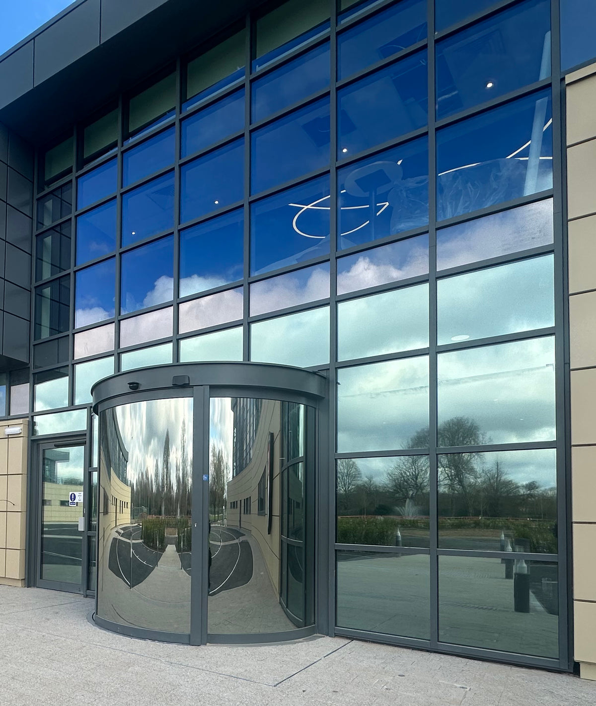 Modern building with glass frontage. Multiple panes have Optiview window film applied to reduce heat and glare.