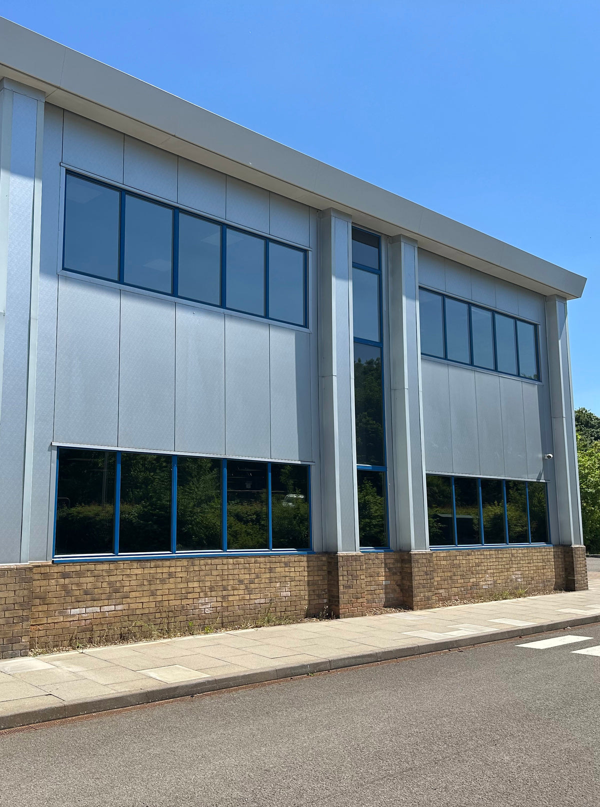 Modern office building with reflective window film applied to the glazing to help reduce heat and glare. 
