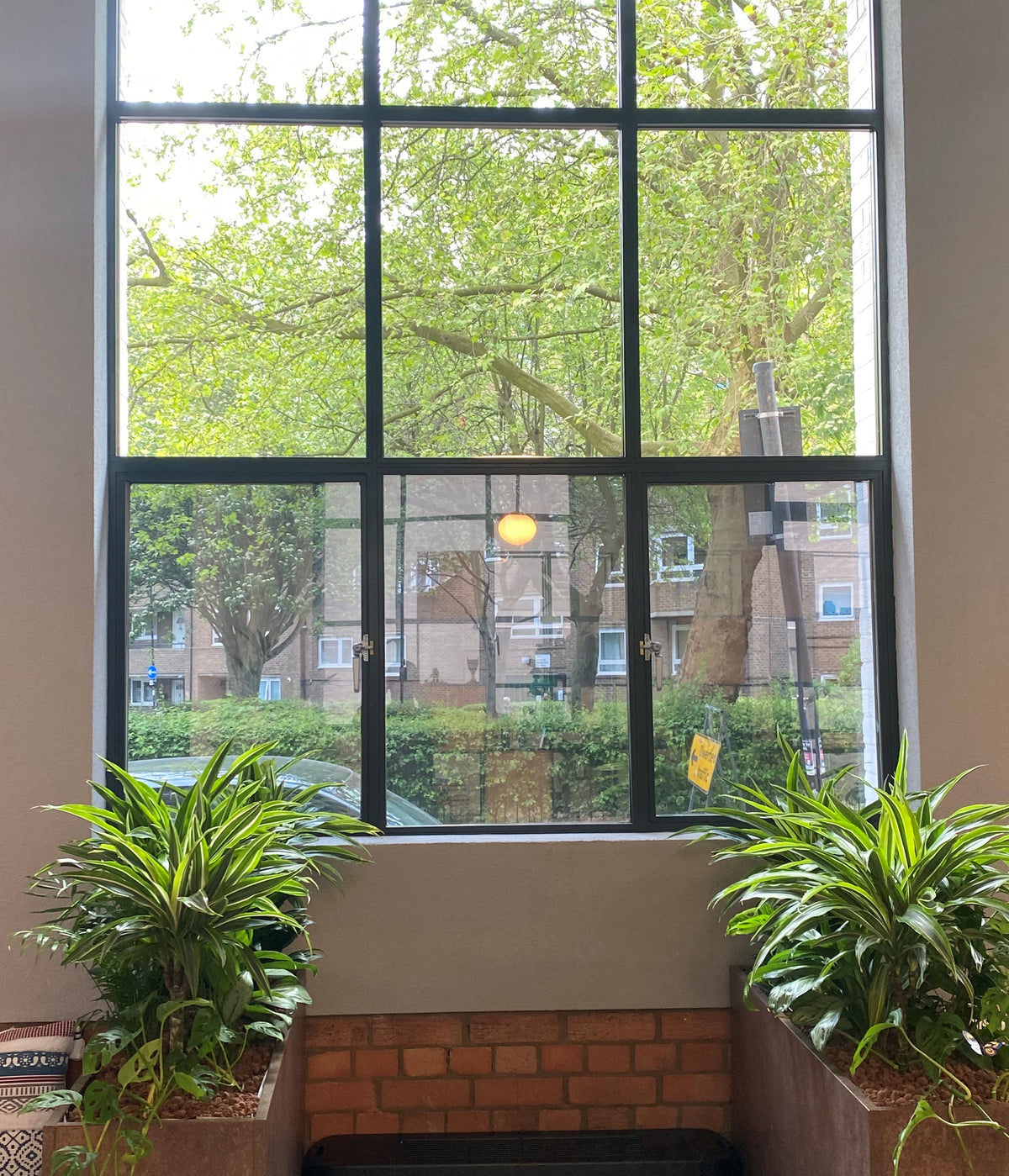Internal view of a window with Optiview window film applied to the lower row of panes delivering a lightly tinted effect.  