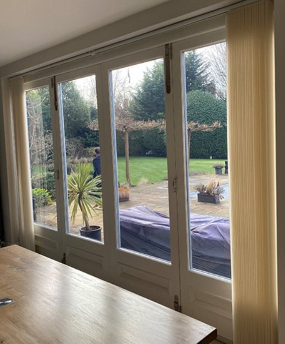An internal view of a residential property with glass patio doors. the glass has Optiview 45 window film applied to it, reducing heat and glare while still allowing a view into the garden.