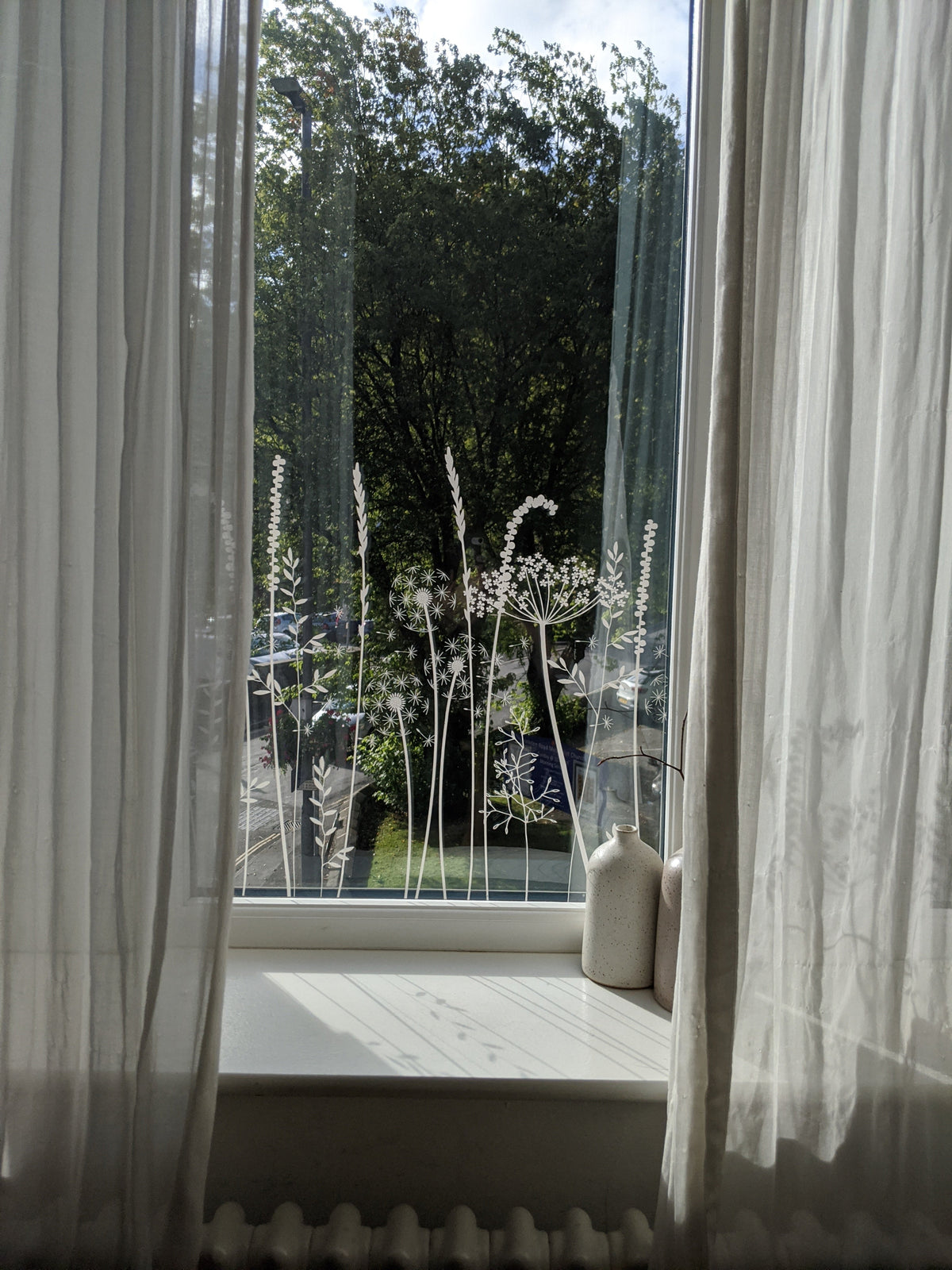 Decorative window film pattern with a floral design applied onto a window.