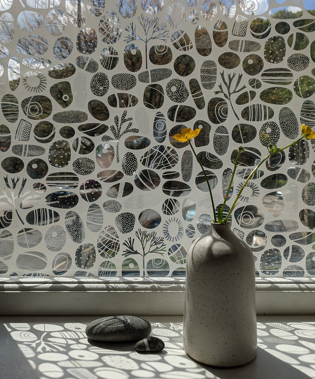 A beach pebble inspired window film design which creates the look similar to etched glass.